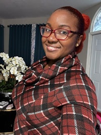 a woman wearing glasses and a plaid shirt