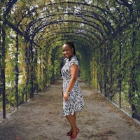 a woman in a zebra print dress standing in an archway